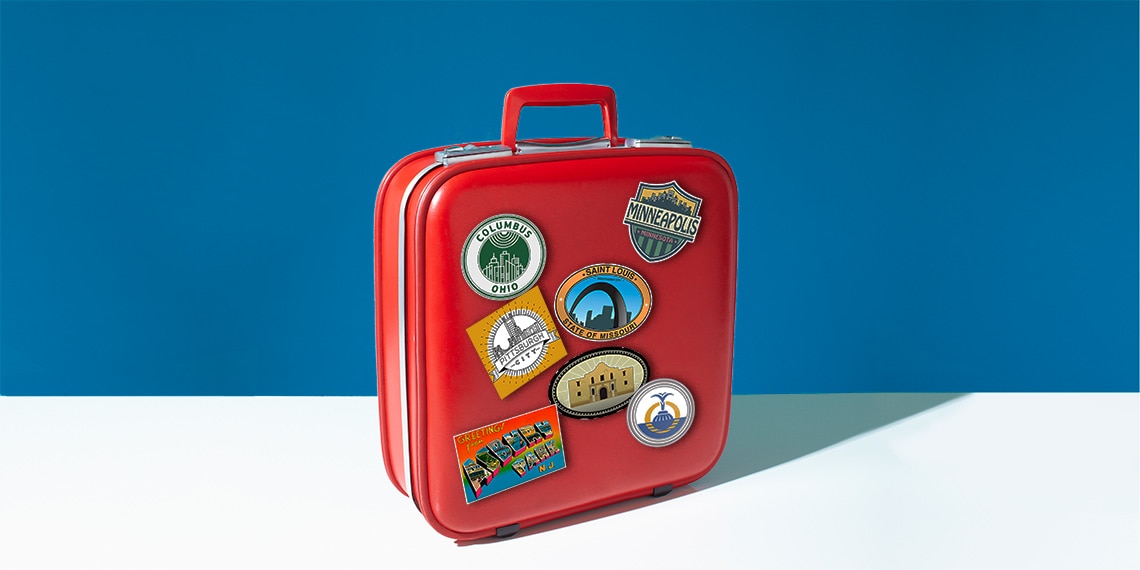 A suitcase with stickers for 7 cities