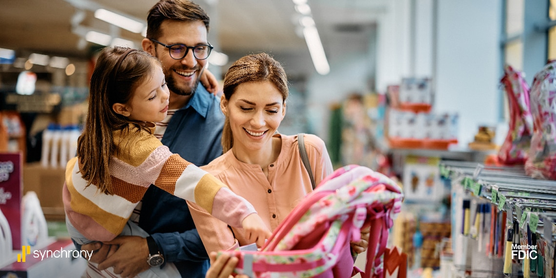 Photo of family in store buying school supplies.