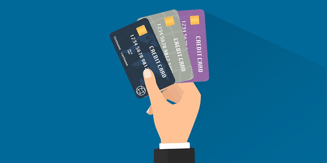 Illustration of a hand holding three different color credit cards.