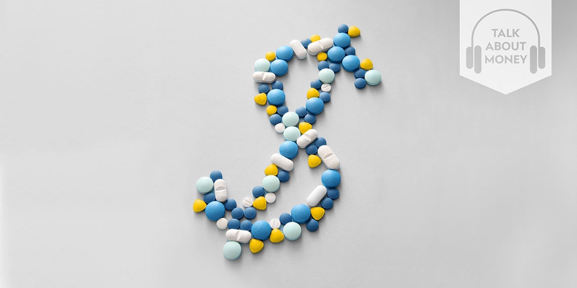 Different colored pills in the shape of a dollar sign.