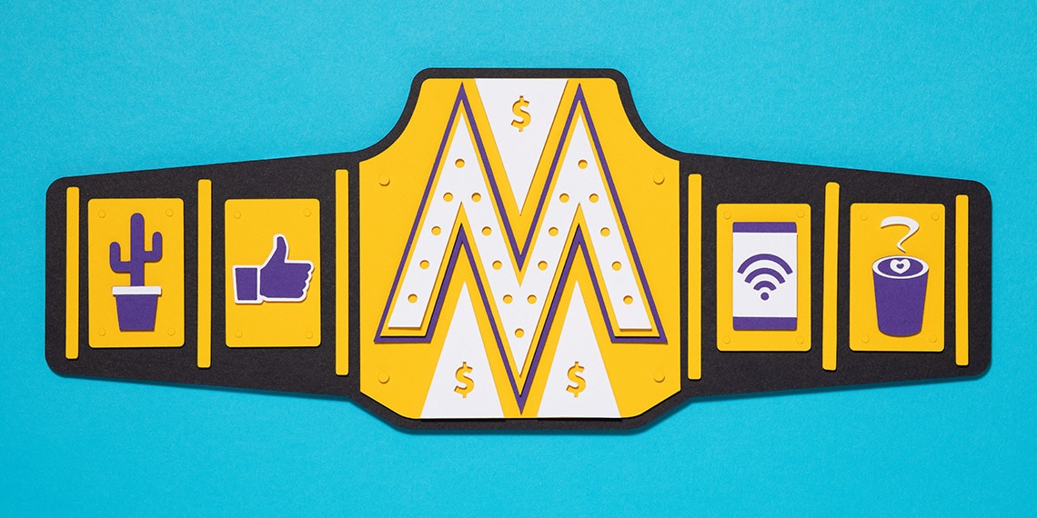 A champion wrestling belt with an M in the center