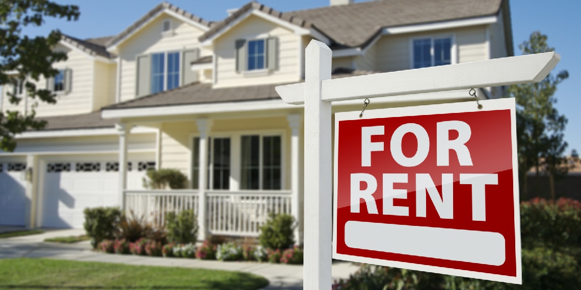 Photo of home with a For Rent sign in the front yard.