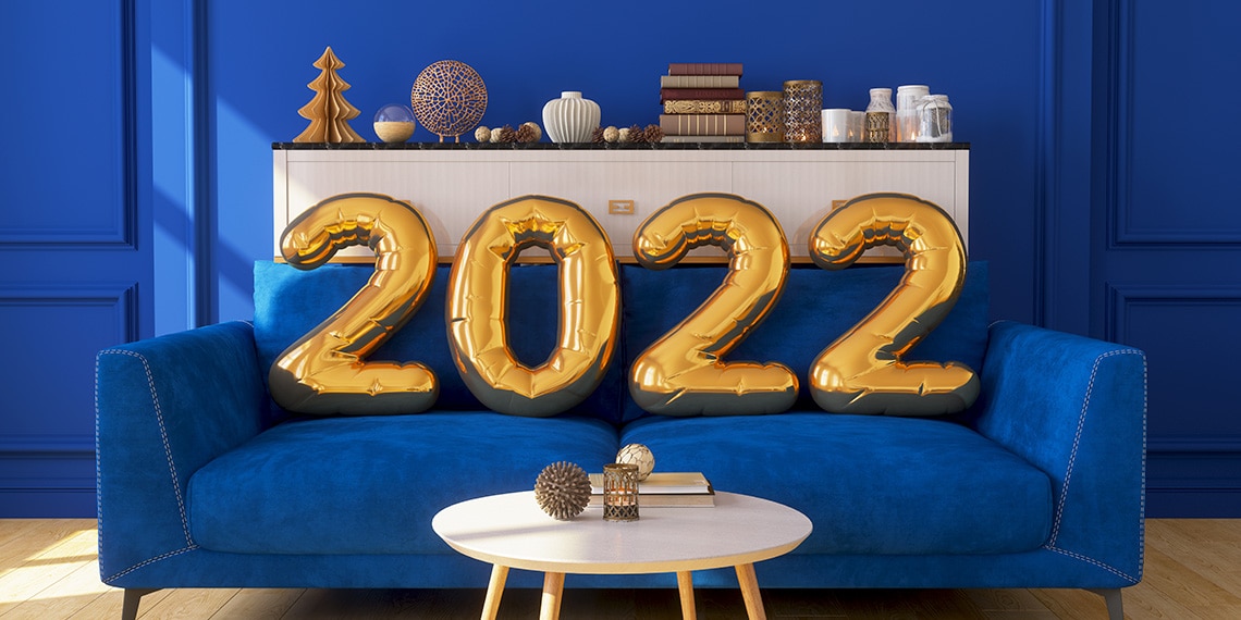 Sofa with gold balloons resting on it that read 2022.