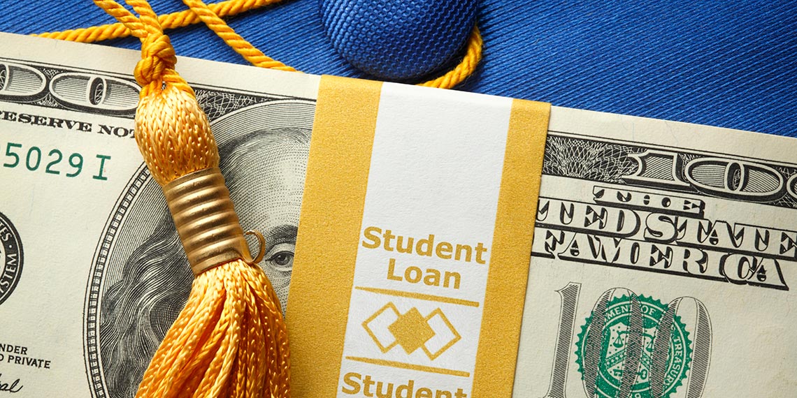 An image of a stack of money on top of a mortarboard.