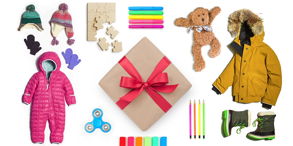 Photo of winter coat, hats, snowsuit and toys with a wrapped box in the center.