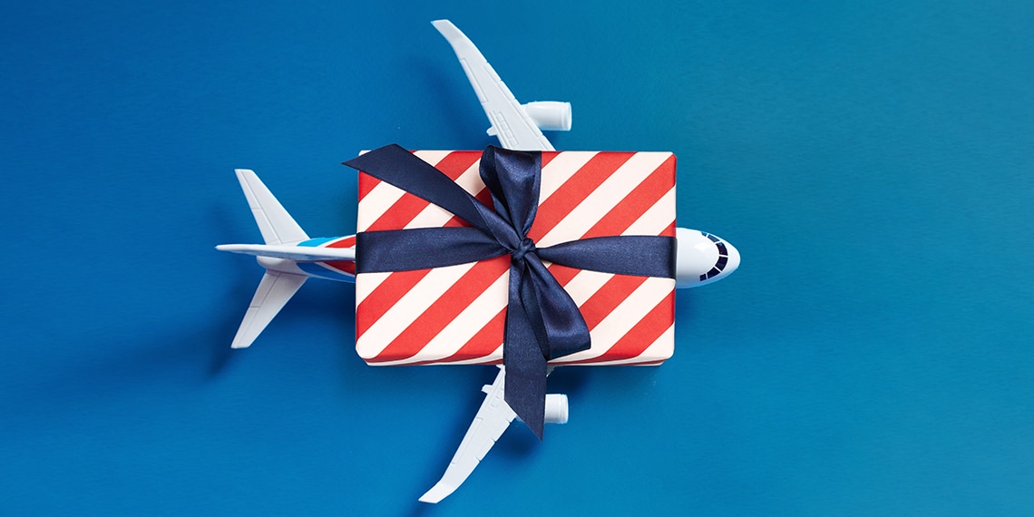 An airplane with a wrapped gift on top.